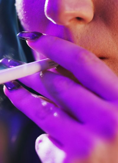 Smoking, party and hands of woman with cigarette for nicotine, tobacco and addiction in nightclub.